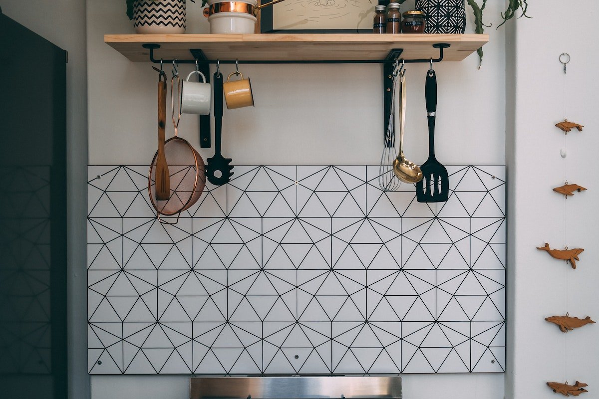 A kitchen with pots and pans on a shelf.